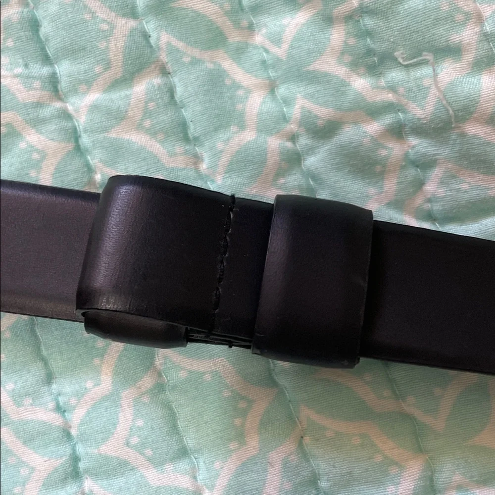 Black leather statement belt with unique silver clasp